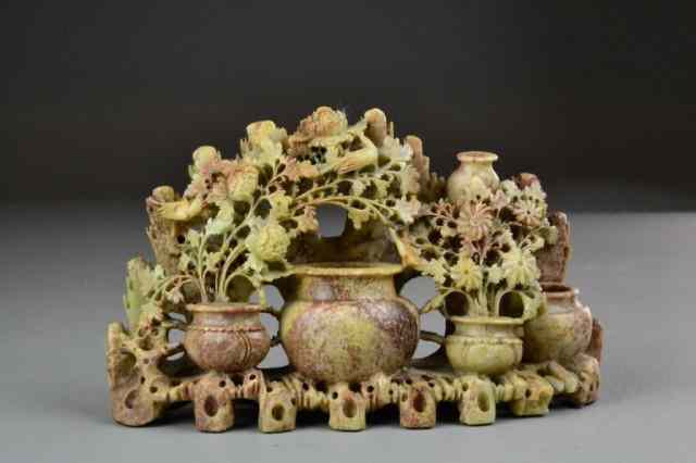 Appraisal: Chinese Carved Soapstone Floral SculptureIntricately carved rose colored soapstone depicting