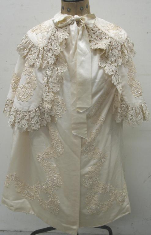 Appraisal: A Victorian cream cape edged with cream lace decorated throughout