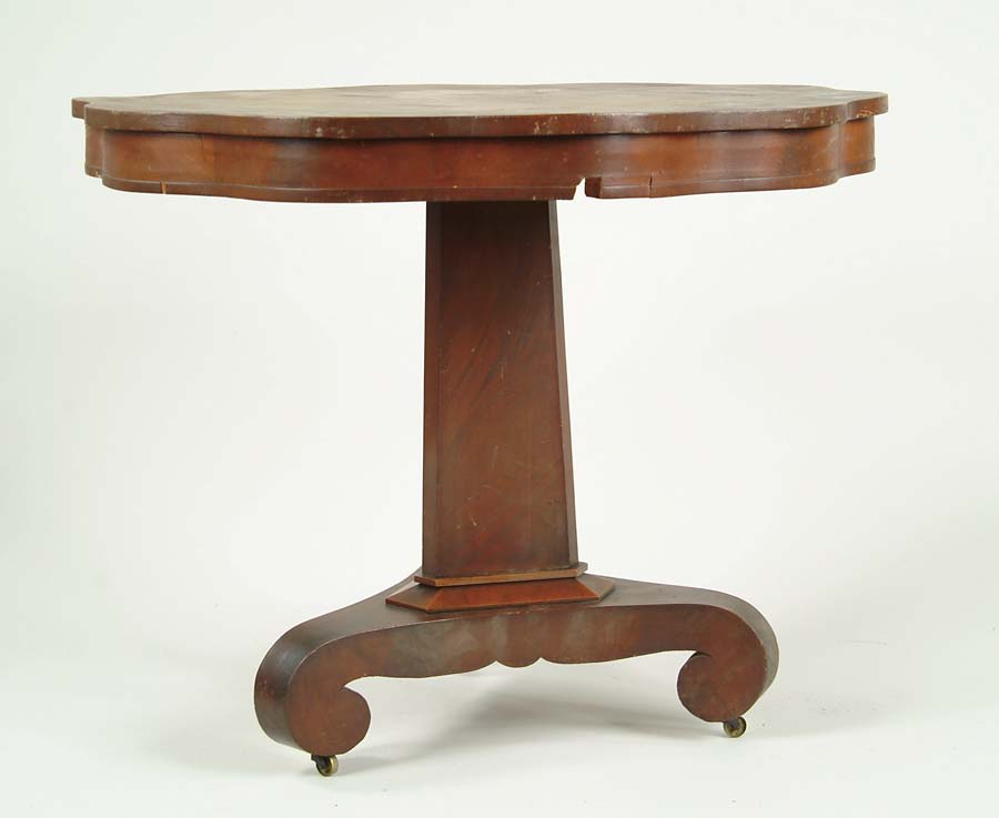 Appraisal: MAHOGANY EMPIRE CENTER TABLE Shaped round top triangular post with