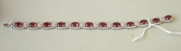 Appraisal: A ct white gold garnet and diamond set bracelet designed