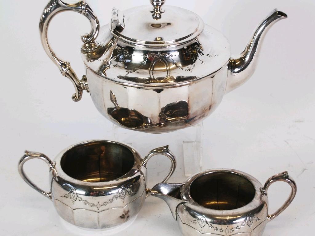 Appraisal: THREE PIECE ELECTROPLATED TEA SERVICE circular with scroll handles and