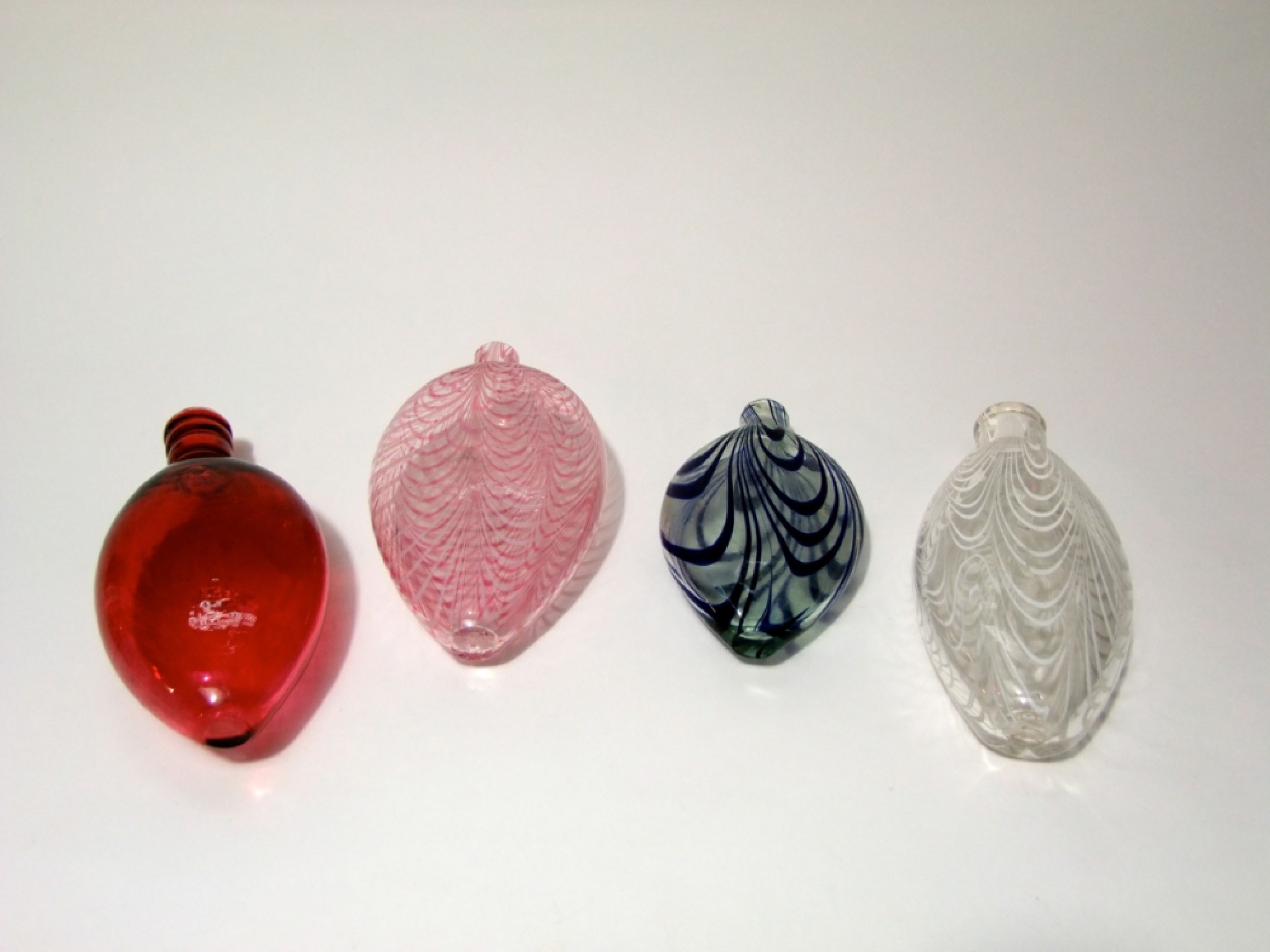 Appraisal: Four th century Nailsea glass flasks one with opaque and