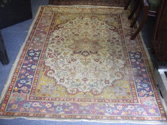 Appraisal: AN EASTERN WHITE GROUND RUG decorated a central foliate medallion