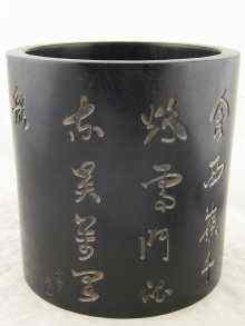 Appraisal: A large heavy black hardwood brushpot with incised Chinese characters