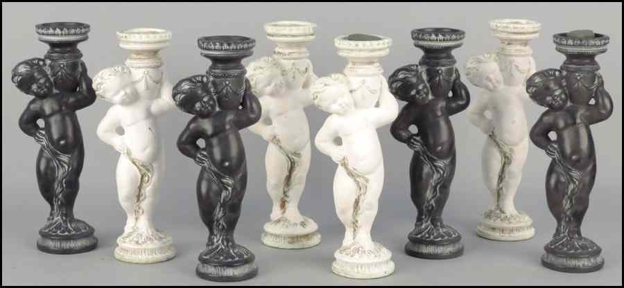 Appraisal: TWO SETS OF COMPOSITE CHERUB CANDLESTICKS Comprised of four white