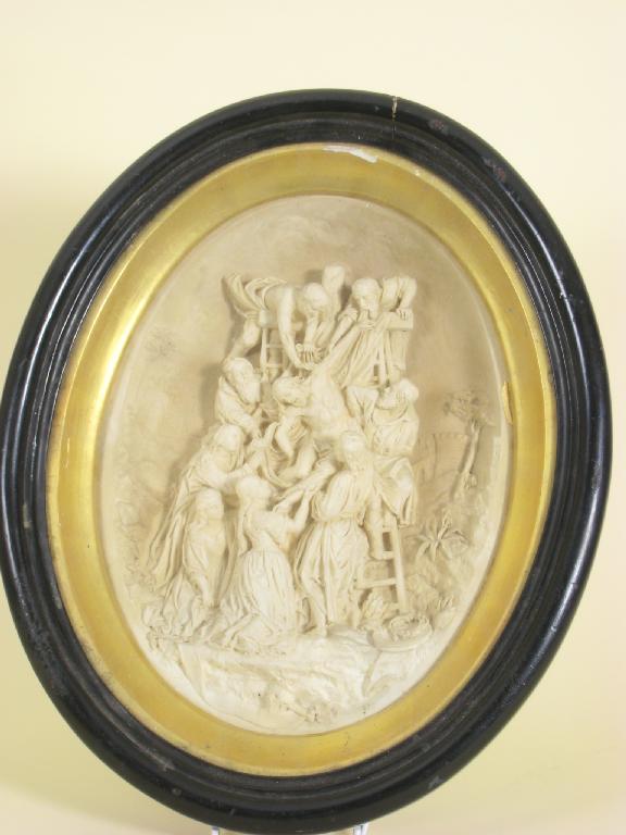 Appraisal: A framed oval Relief of Christ being taken down from