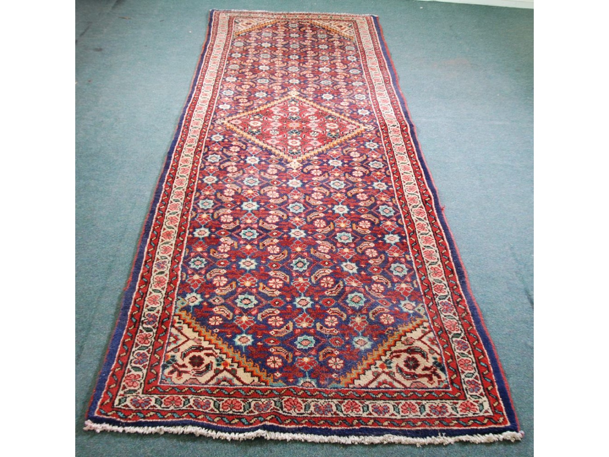 Appraisal: SHIRAZ PERSIAN RUNNER With diamond shaped crimson medallion on a