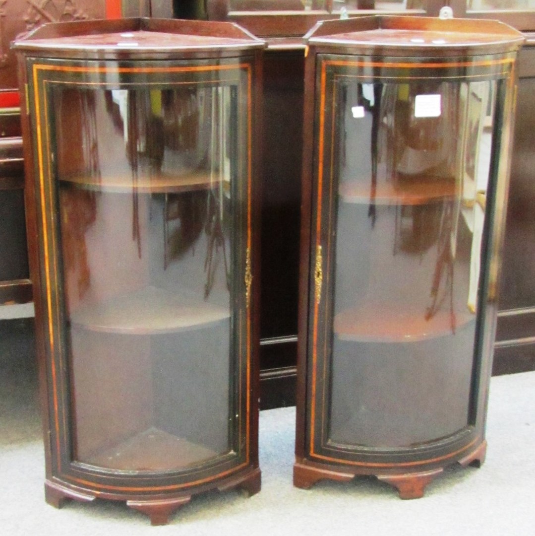 Appraisal: A pair of inlaid mahogany bowfront corner display cabinets cm