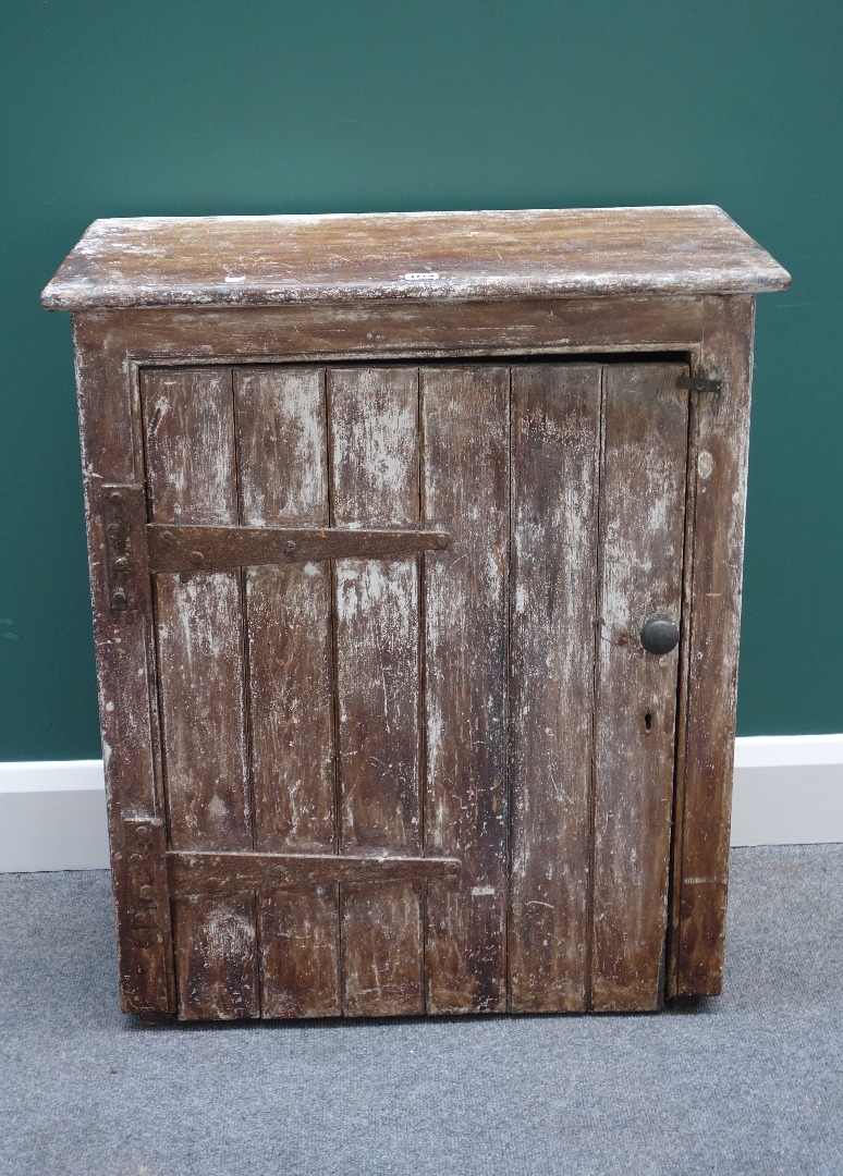 Appraisal: A late th century distressed painted single door cupboard cm