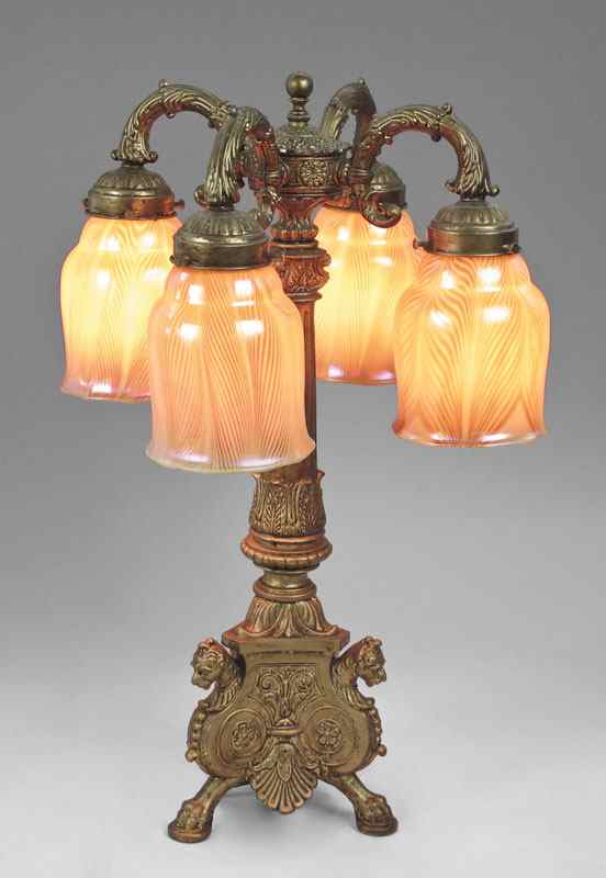 Appraisal: STUDIO ART GLASS SHADES ON OLDER LAMP Ornate patinated cast