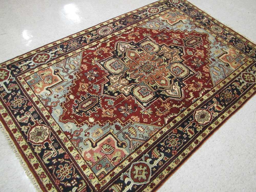 Appraisal: HAND KNOTTED ORIENTAL AREA RUG Indo-Heriz central geometric medallion and