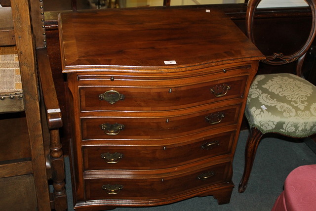 Appraisal: A REPRODUCTION YEW WOOD SERPENTINE CHEST of four graduated drawers