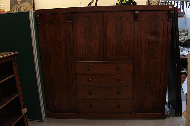 Appraisal: A WILLIAM IV MAHOGANY WARDROBE the central section with twin