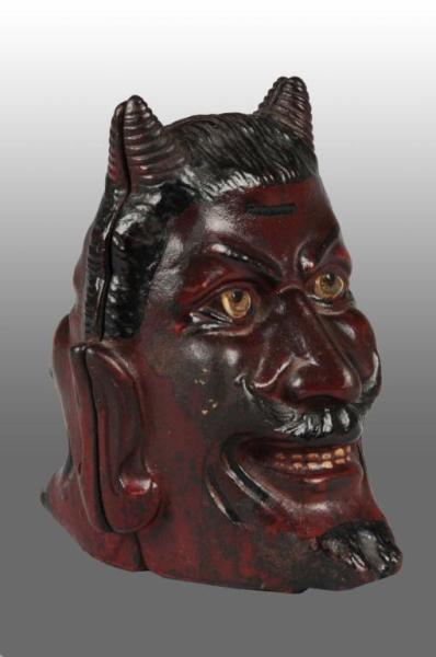 Appraisal: Cast Iron Two-Faced Devil Still Bank Description Manufactured by A