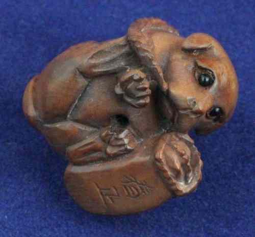 Appraisal: A wooden netsuke signed in the form of a puppy