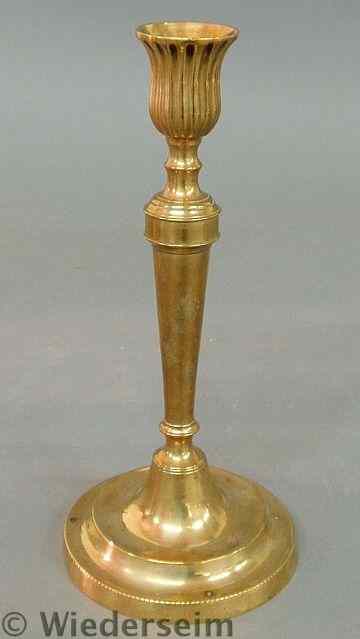 Appraisal: French brass candlestick c with a reeded socket and circular