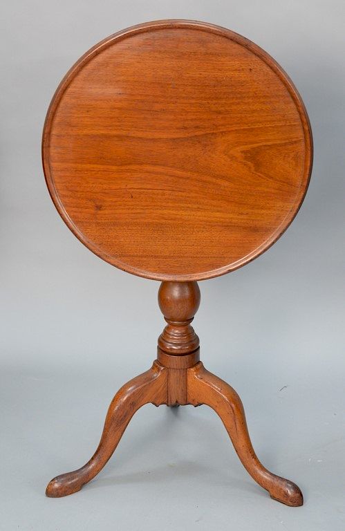 Appraisal: Mahogany dish top tip table on turned shaft set on