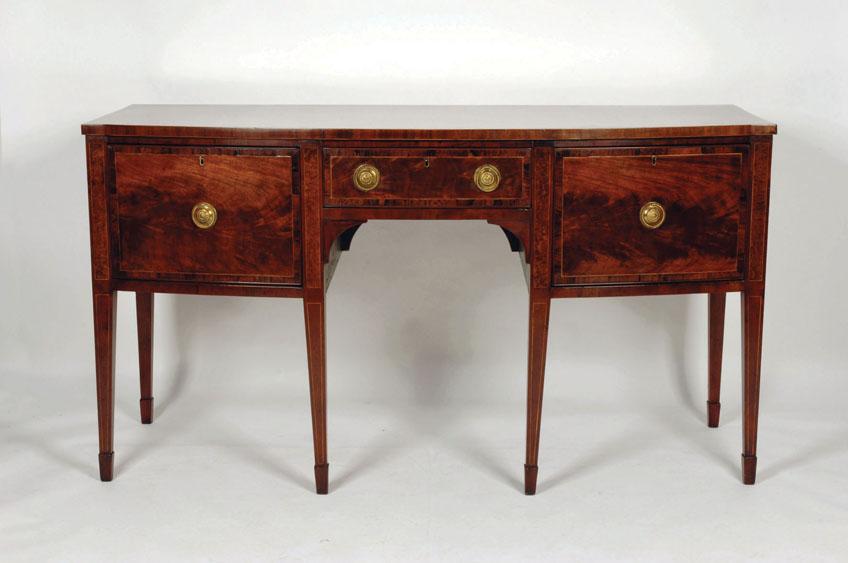 Appraisal: A GEORGE III MAHOGANY SIDEBOARD with a bow fronted top