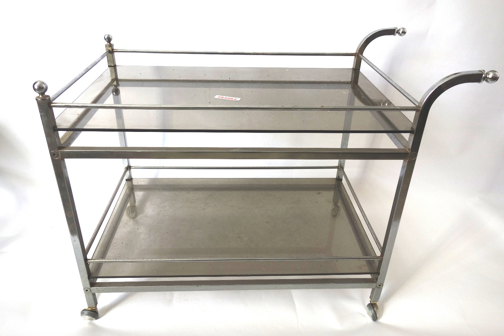 Appraisal: A retro steel frame two tier trolley with smoked glass