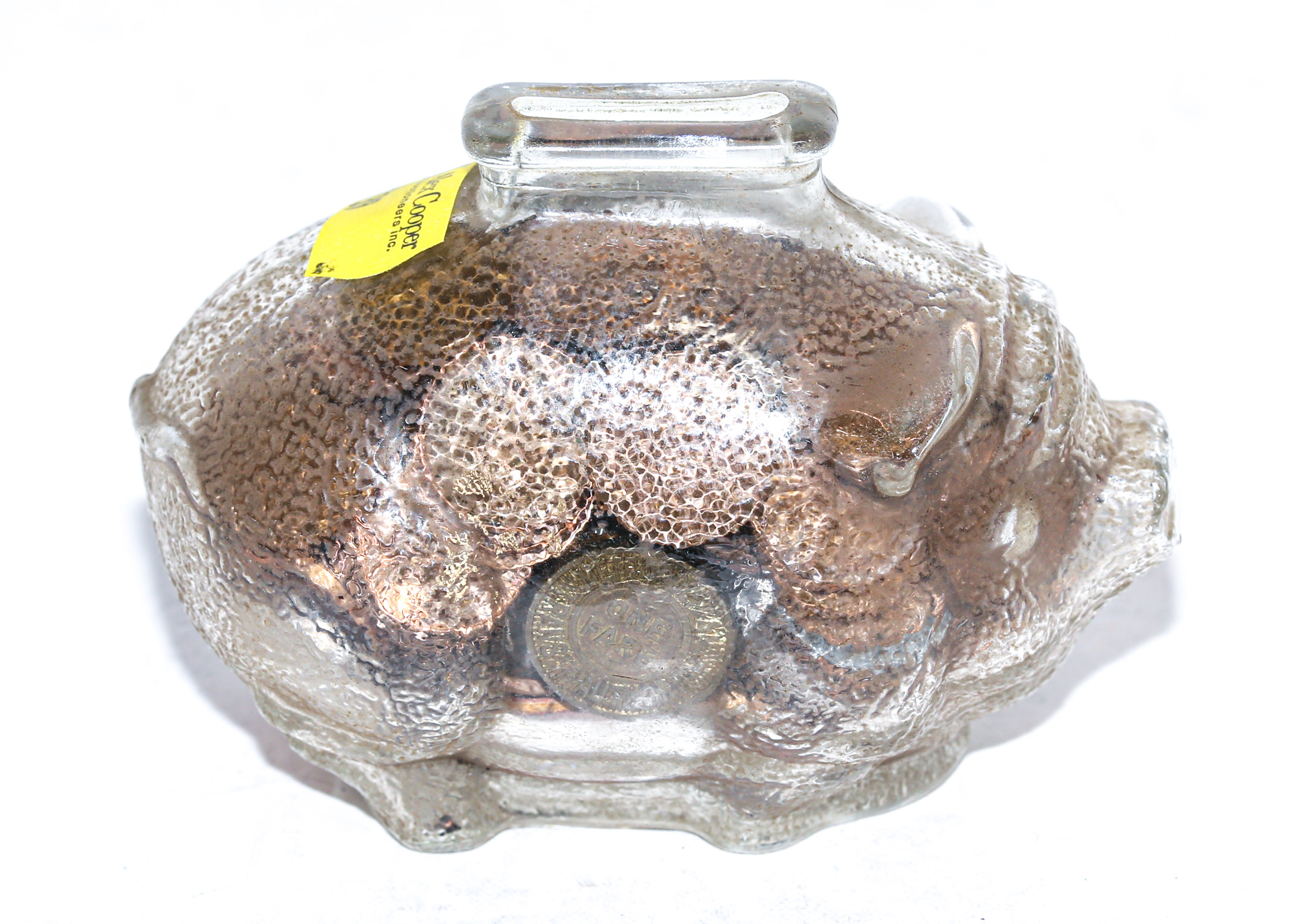 Appraisal: GLASS PIGGY BANK FILLED WITH COINS Foreign and US coins