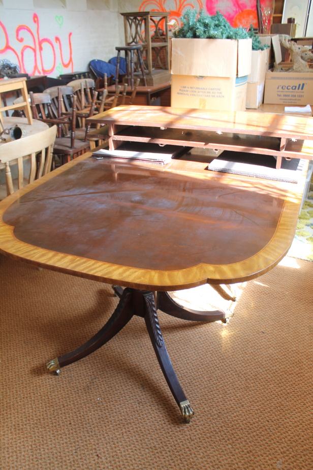 Appraisal: A Reproduction Regency crossbanded mahogany dining table