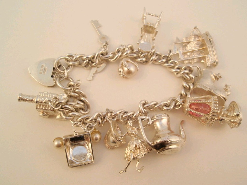 Appraisal: A silver curb bracelet with eleven attached charms g all