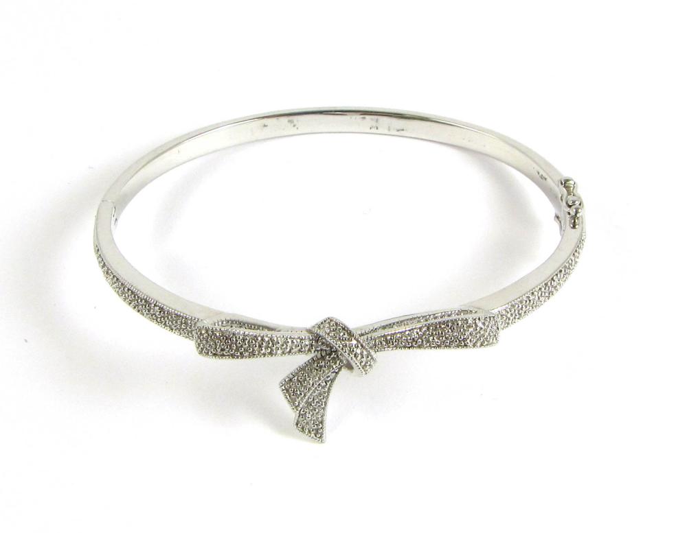 Appraisal: DIAMOND AND STERLING SILVER BANGLE The oval hinged sterling silver