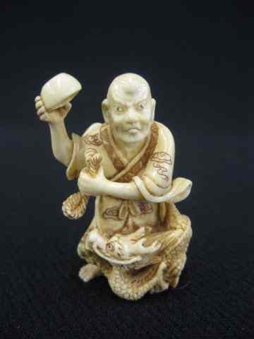 Appraisal: Carved Ivory Netsuke of a Manwith dragon and empty bowl