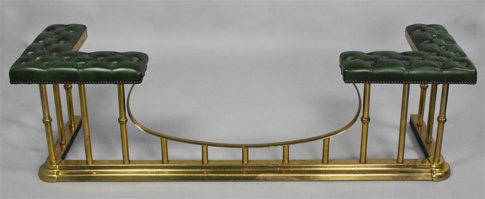 Appraisal: A BRASS AND LEATHER UPHOLSTERED CLUB FENDER having a tufted