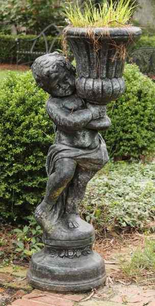 Appraisal: Cast Stone Figural Planterin the form of a putti holding