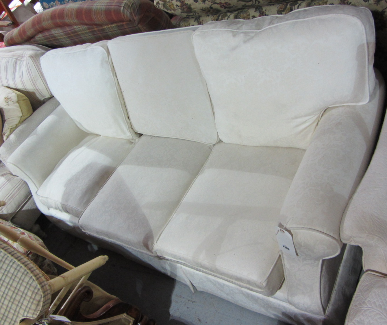 Appraisal: A th century cream upholstered two seat sofa