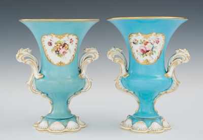 Appraisal: A Pair of Porcelain Urns The double handled fancy urns