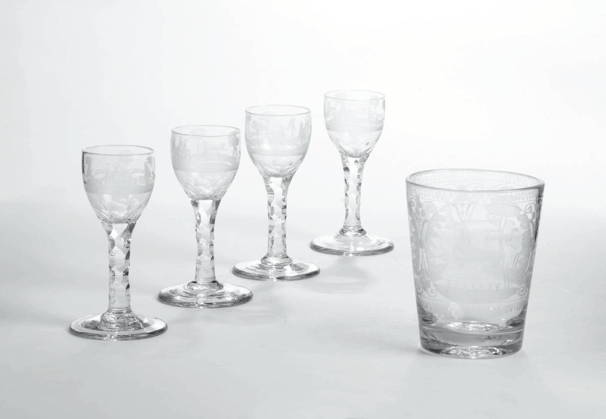 Appraisal: COLORLESS ENGRAVED FLIP GLASS AND SET OF FOUR WINE GLASSES