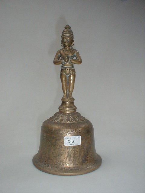 Appraisal: A Hindu bronze bell with cast god handle