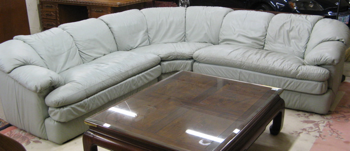 Appraisal: CONTEMPORARY THREE-PIECE LEATHER SECTIONAL SOFA SET comprising corner section and