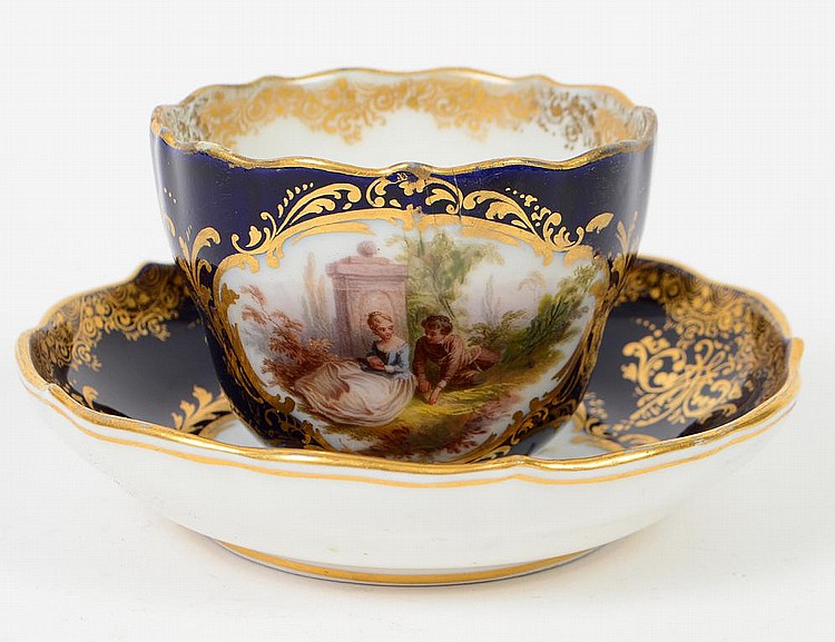 Appraisal: MEISSEN COBALT GROUND TEA CUP AND SAUCER th Century Painted