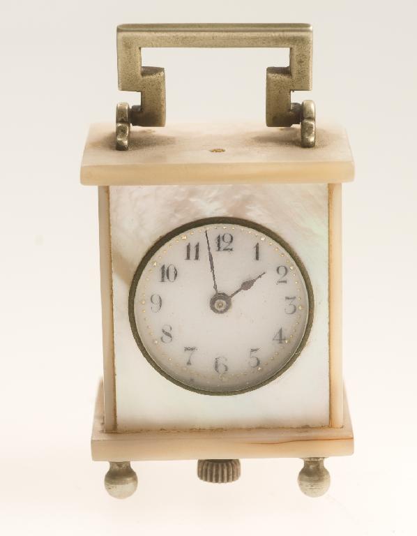 Appraisal: MINIATURE MOTHER-OF-PEARL CASED TIMEPIECE OF CARRIAGE CLOCK STYLE with circular