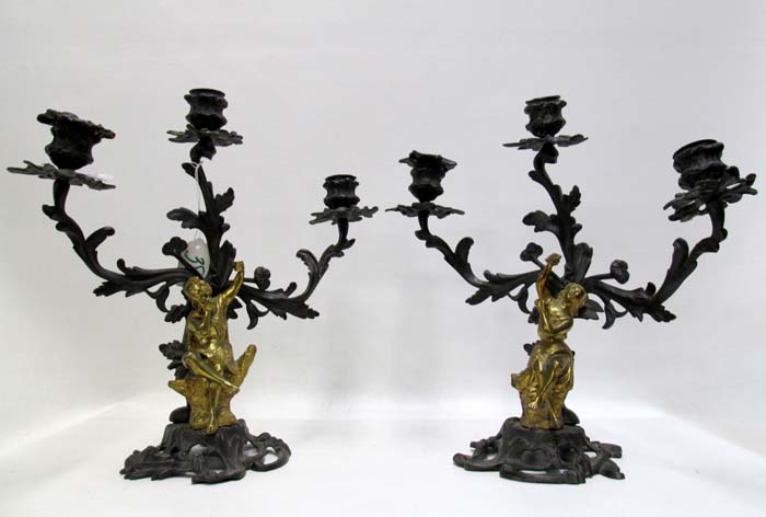 Appraisal: PAIR FIGURAL BRONZE CANDELABRA with seated gilt figures each having