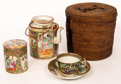 Appraisal: A Cantonese teapot and cover in a fitted rattan carrying