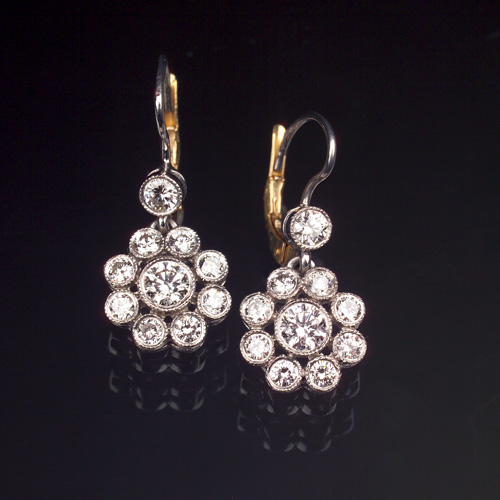 Appraisal: DIAMOND Cluster earrings in platinum Each earring has a central