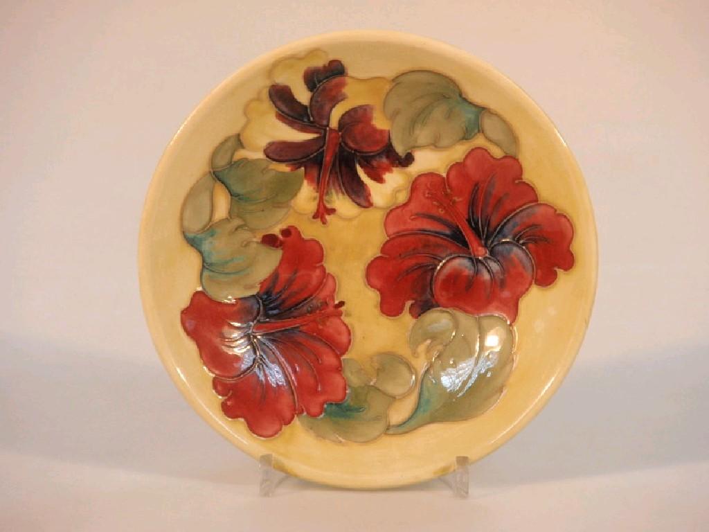 Appraisal: A Moorcroft circular dish decorated with lilies on a pale