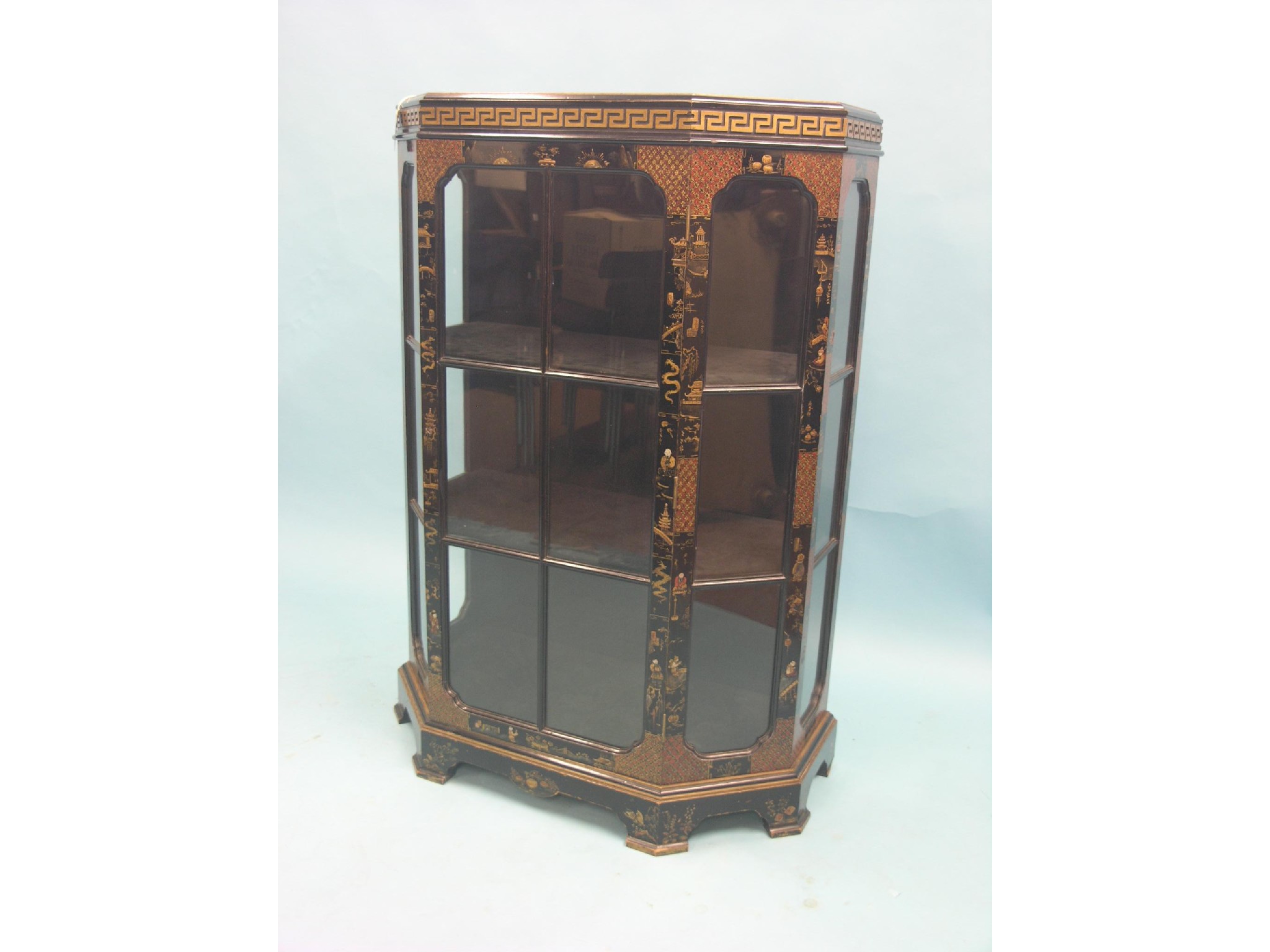 Appraisal: A black-lacquered and chinoiserie display cabinet canted form with single