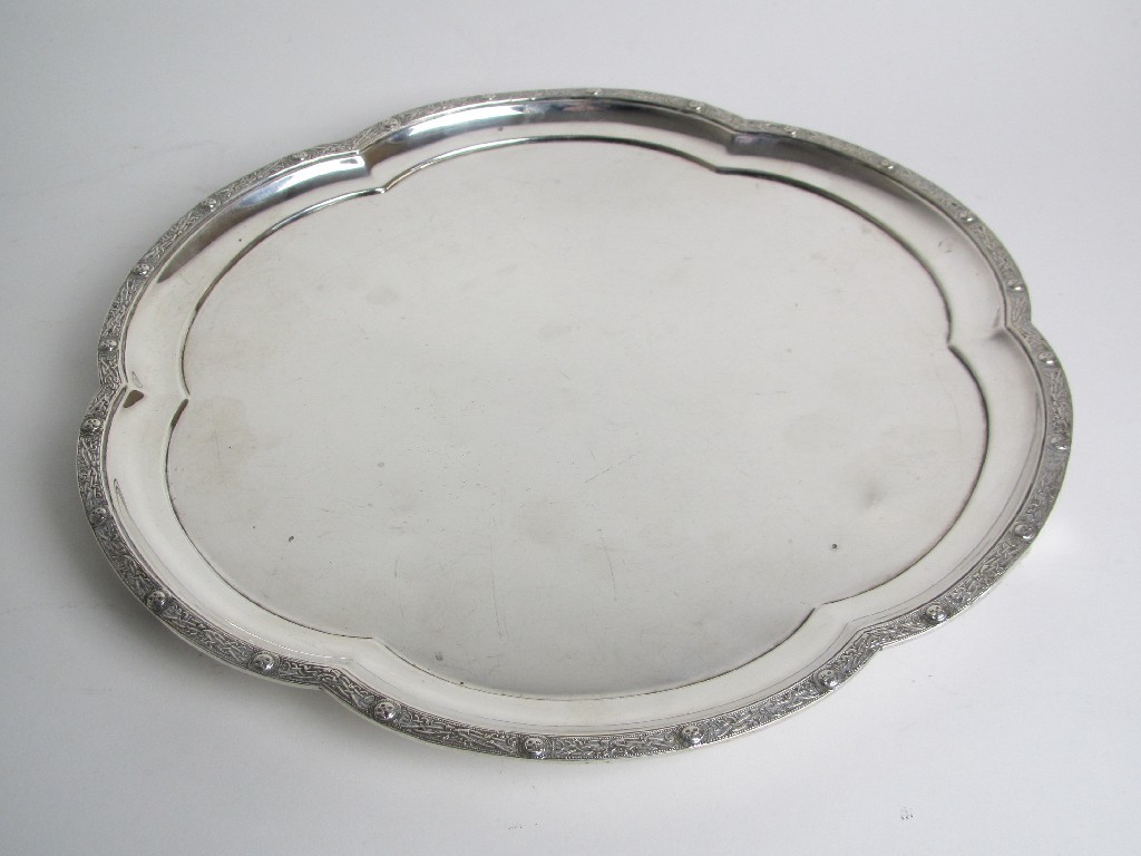 Appraisal: A silver salver of shaped circular form with raised border