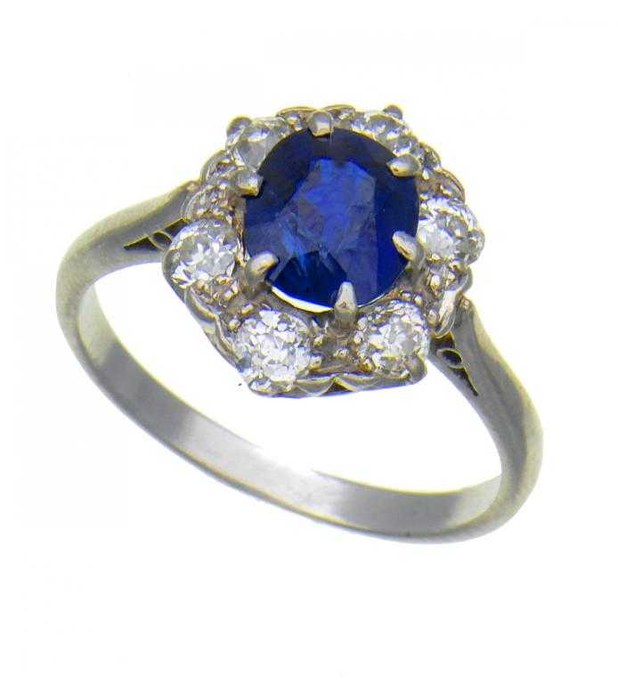 Appraisal: A SAPPHIRE AND DIAMOND CLUSTER RING with larger cushion shaped