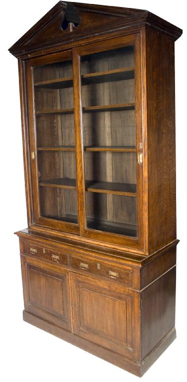 Appraisal: th CENTURY OAK BOOKCASE CABINET with dentilled broken pediment above