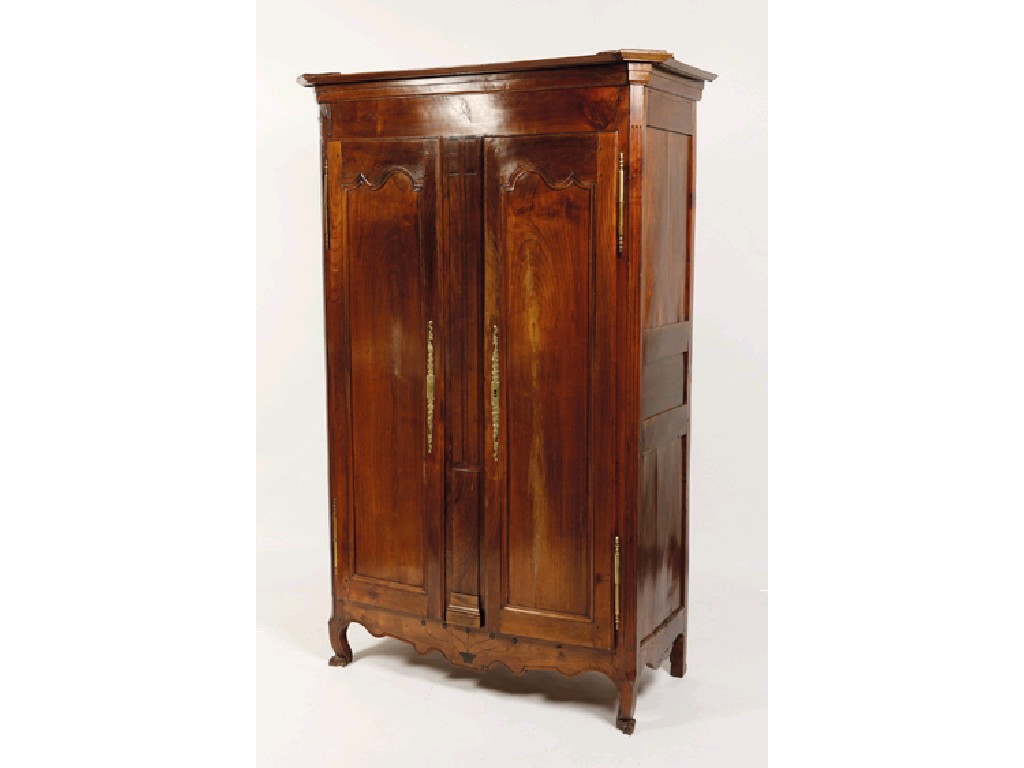 Appraisal: A FRENCH CHESTNUT ARMOIRE the shaped cornice with a central