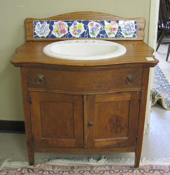 Appraisal: LATE VICTORIAN OAK WASHSTAND American c having a bow-front drawer