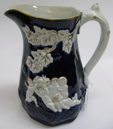 Appraisal: ENGLISH GLAZED POTTERY PITCHER having raised cherubs and leaves design