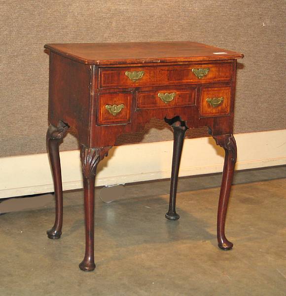 Appraisal: A George II walnut and cross banded dressing table first