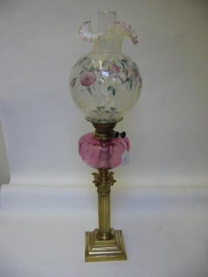 Appraisal: A VICTORIAN BRASS TABLE LAMP the cranberry glass reservoir on